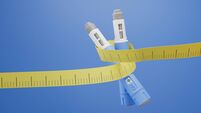 Two injectors / dosing pens  for subcutaneous injection of antidiabetic medication or anti-obesity medication hovering over a bl