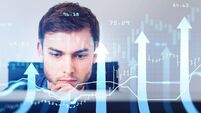 Portrait of businessman, stock traders analyzing stock data to apply new strategy to beat the market. Using desktop computer to